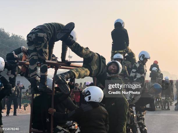 India's Border Security Force &quot;Daredevils&quot; women motorcycle riders help their colleague to balance on a bike during a rehearsal for the...