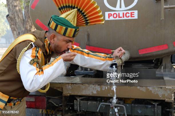 An Indo-Tibetan Border Police soldier drinks water after rehearsing for the upcoming 69th Republic Day Parade in New Delhi on January 13, 2018.