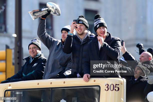 Nick Foles hoists the Vince Lombardi Trophy as team owner Jeffrey Lurie Nate Sudfeld and Carson Wentz of the Philadelphia Eagles ride on a parade...