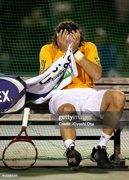 Juan Monaco of Argentina reacts due to his leg injury in his match against Ernests Gulbis of Latvia during day four of the Rakuten Open Tennis...