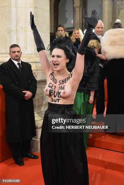 An activist of women's rights movement Femen demonstrates on the red carpet prior the opening of the Opera Ball 2018, the sumptuous highlight of the...