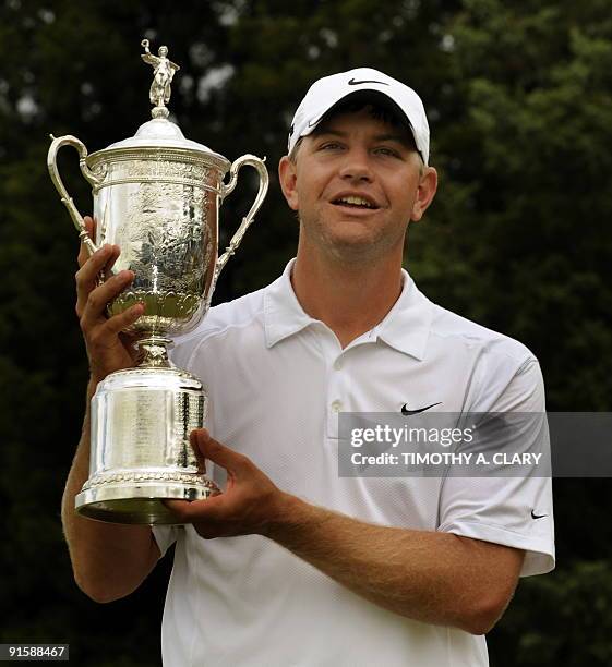Lucas Glover of the US holds his trophy after winning the US Open golf championship on the Black Course at Bethpage State Park in Farmingdale, New...
