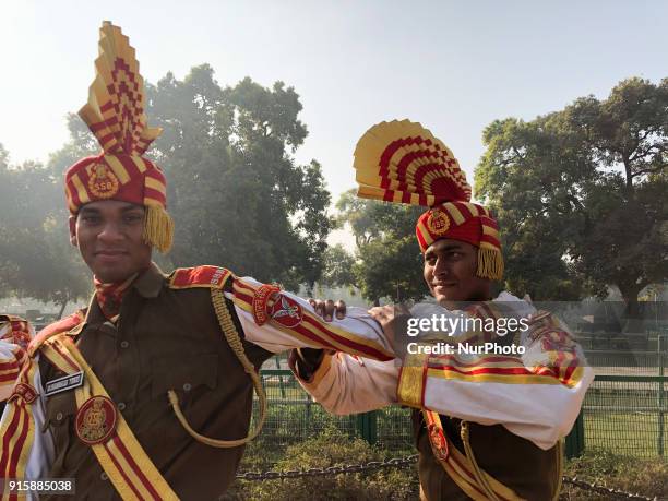 Sashastra Seema Bal soldiers relax by massaging each other during their rehearsal for the Republic Day parade on a winter morning in New Delhi....