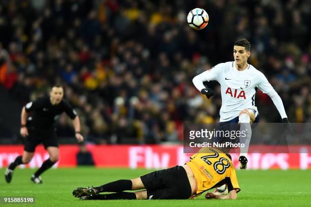 Mickey Demetriou of Newport County gets caught up with Tottenham Hotspur's Erik Lamela during the FA Cup Fourth Round replay match between Tottenham...