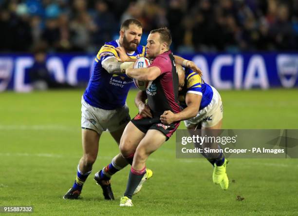 Hull KR's Adam Quinlan is tackled by Leeds Rhinos' Adam Cuthbertson and Jamie Jones-Buchanan during the Betfred Super League match at Elland Road,...