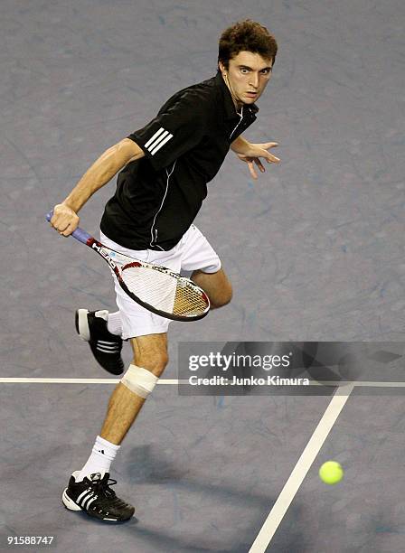 Gilles Simon of France plays a backhand in his match against Mikhail Youzhny of Russia during day four of the Rakuten Open Tennis tournament at...