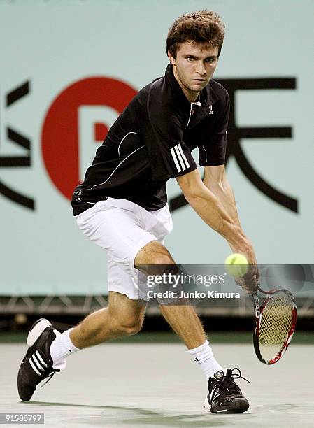 Gilles Simon of France plays a backhand in his match against Mikhail Youzhny of Russia during day four of the Rakuten Open Tennis tournament at...