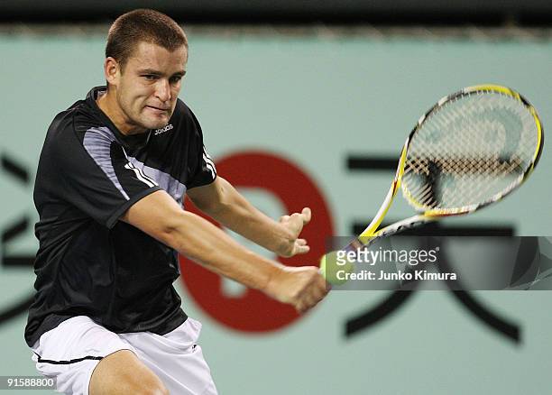 Mikhail Youzhny of Russia plays a backhand in his match against Gilles Simon of France during day four of the Rakuten Open Tennis tournament at...
