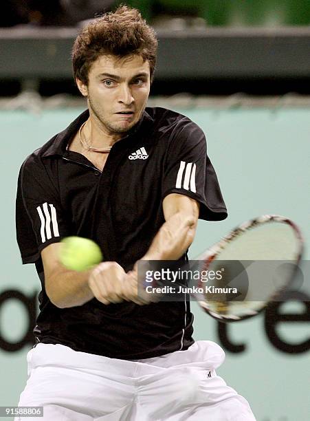 Gilles Simon of France plays a backhand in his match against Mikhail Youzhny of Russia during day four of the Rakuten Open Tennis tournament at...