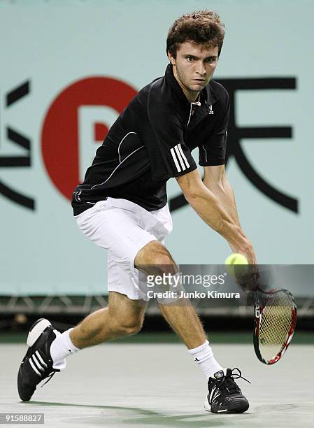 Gilles Simon of France plays a backhand in his match against Mikhail Youzhny of Russia during day four of the Rakuten Open Tennis tournament at...