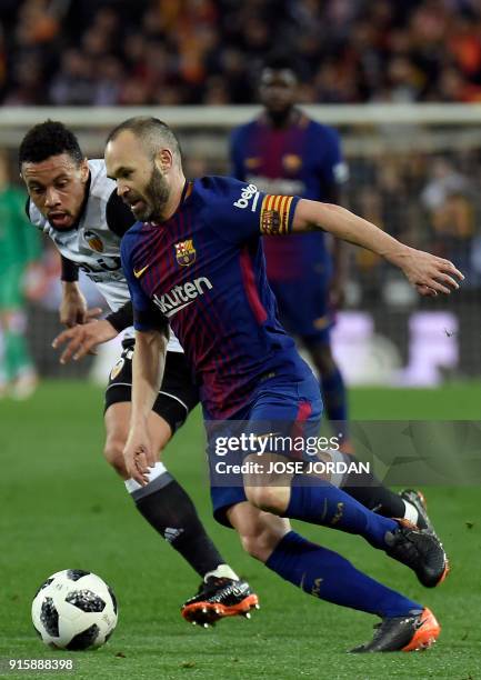 Barcelona's Spanish midfielder Andres Iniesta vies with Valencia's French midfielder Francis Coquelin during the Spanish 'Copa del Rey' second leg...