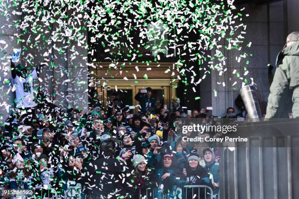 Eagles fans are doused with ticker tape confetti during festivities on February 8, 2018 in Philadelphia, Pennsylvania. The city celebrated the...