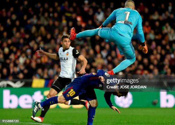 Valencia's Spanish goalkeeper Jaume jumps over Barcelona's Argentinian forward Lionel Messi during the Spanish 'Copa del Rey' second leg semi-final...