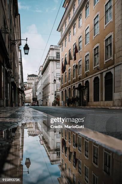 reflections of lisbon - cobblestone puddle stock pictures, royalty-free photos & images