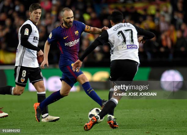 Barcelona's Spanish midfielder Andres Iniesta vies with Valencia's French midfielder Francis Coquelin during the Spanish 'Copa del Rey' second leg...