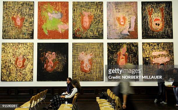 Visitors look at paintings called "45" by German artist Georg Baselitz on October 8, 2009 in the "Gemaeldegalerie Alte Meister" at the Zwinger museum...