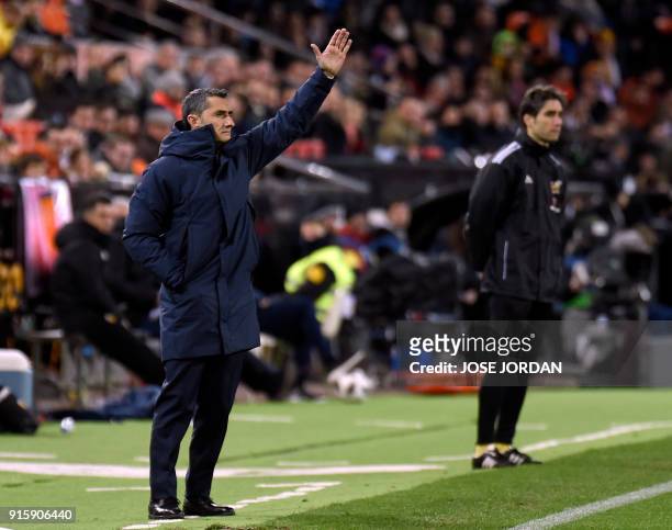 Barcelona's Spanish coach Ernesto Valverde gestures during the Spanish 'Copa del Rey' second leg semi-final football match between Valencia CF and FC...