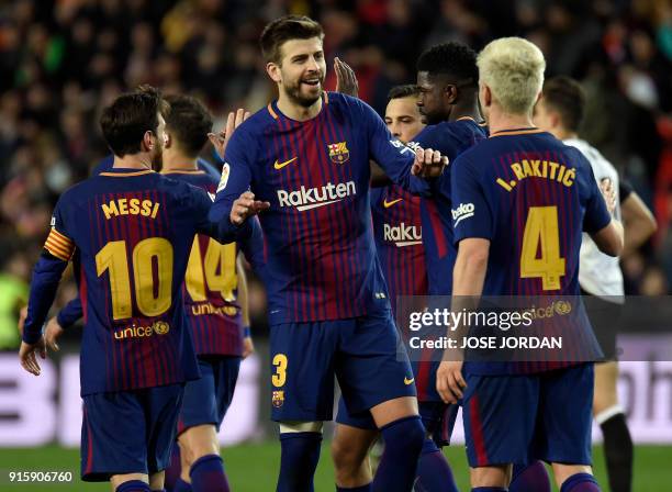 Barcelona's Spanish defender Gerard Pique congratulates Barcelona's Croatian midfielder Ivan Rakitic for his goal during the Spanish 'Copa del Rey'...