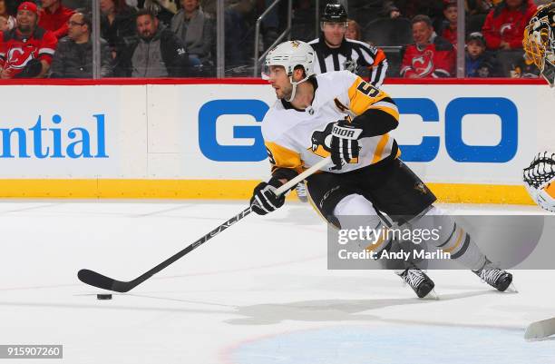 Kris Letang of the Pittsburgh Penguins plays the puck against the New Jersey Devils during the game at Prudential Center on February 3, 2018 in...