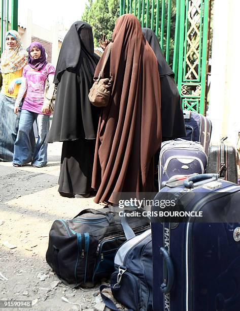 Cairo University students wearing the hijab , a veil which covers the hair, walk freely on campus next to women wearing a niqab, the black veil which...