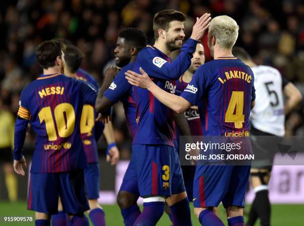 Barcelona's Spanish defender Gerard Pique congratulates Barcelona's Croatian midfielder Ivan Rakitic after scoring their team's second goal during...