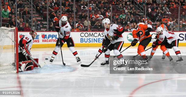 Claude Giroux and Sean Couturier of the Philadelphia Flyers take a shot on goal against Craig Anderson, Johnny Oduya, Jean-Gabriel Pageau and Tom...