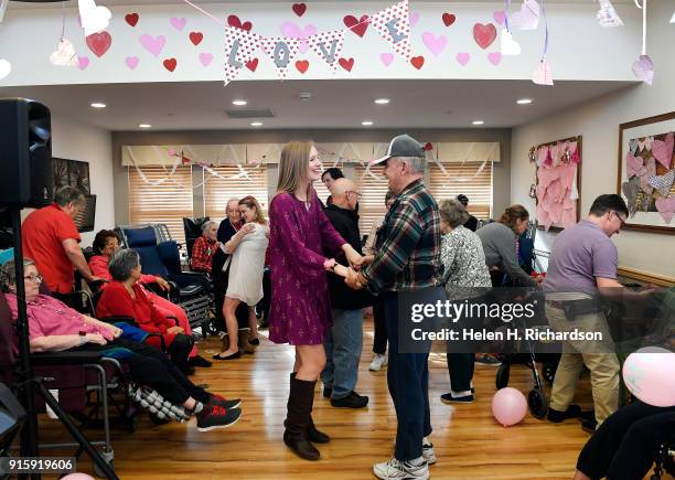 Carly Schwulst left, dances with Chelsea Place resident Ken Gould as they take part in a pre-Valentine's day dance at Chelsea Place on February 8,...