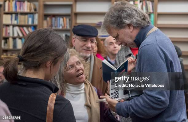 Mozambican writer Antonio Emlio Leite Couto , better known as Mia Couto, signs one of his books at the end of his speech in Camoes Institute program...