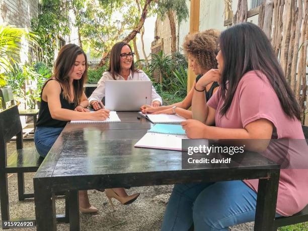 group of women business people having a casual meeting outside - maori business stock pictures, royalty-free photos & images