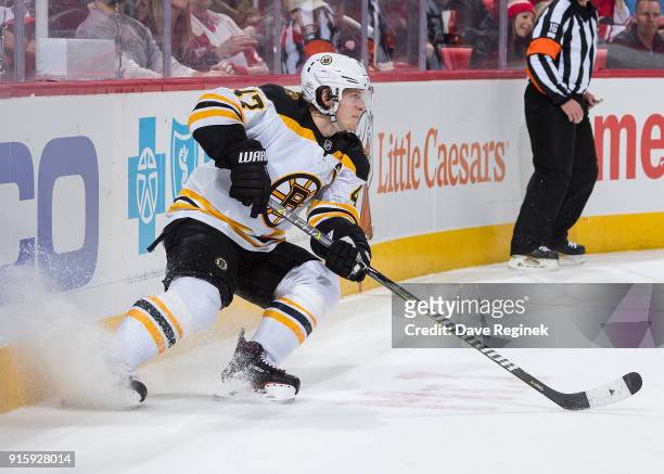 Torey Krug of the Boston Bruins stops behind the net against the Detroit Red Wings during an NHL game at Little Caesars Arena on February 6, 2018 in...