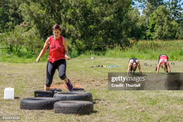 women completing obstacle course at outdoor training session - australia training session stock pictures, royalty-free photos & images