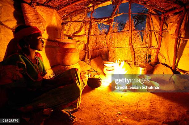 An IDP checks her cooking fire at the IDP camp near the UNAMID base in Mukvar.