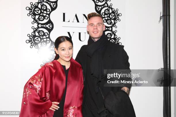 Designer Lan Yu and recording artist Russian Roulette pose backstage for Lanyu during New York Fashion Week: The Shows at Industria Studios on...