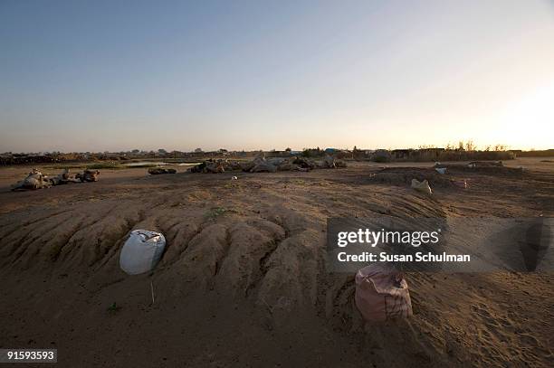 The mass graves of the 35 people killed in the incident described below, with Kalma camp visible in the background. On August 25, GoS forces...