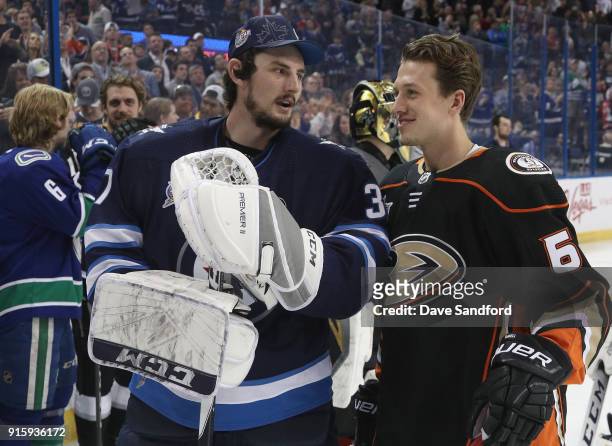 Connor Hellebuyck of the Winnipeg Jets talks with Rickard Rakell of the Anaheim Ducks during 2018 GEICO NHL All-Star Skills Competition at Amalie...