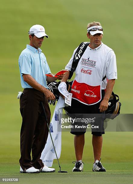 Mike Weir of Canada and caddie Brennan Little look on during the first round of THE TOUR Championship presented by Coca-Cola, the final event of the...