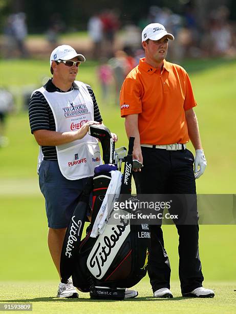 Marc Leishman of Australia and his caddie look on during the first round of THE TOUR Championship presented by Coca-Cola, the final event of the PGA...