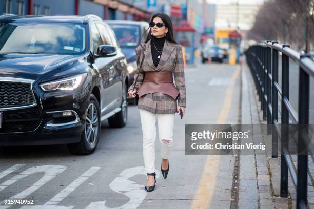 Lainy Hedaya wearing white pants, corset, checked blazer seen outside Creatures of Comfort on February 8, 2018 in New York City.
