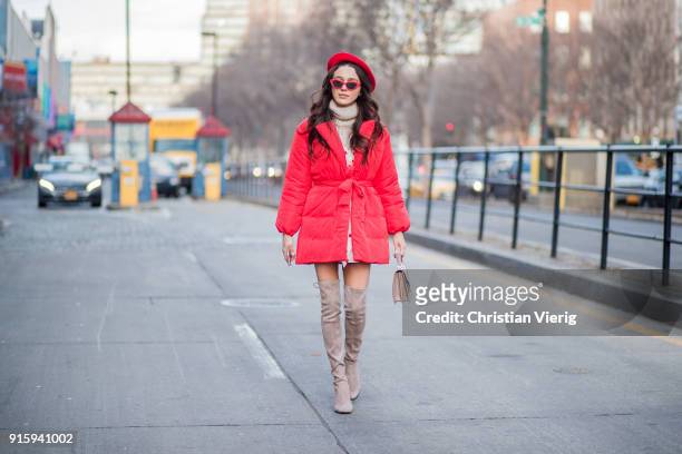 Mary Leest wearing red beret, turtleneck, red puffer jacket, overknees boots seen outside Creatures of Comfort on February 8, 2018 in New York City.