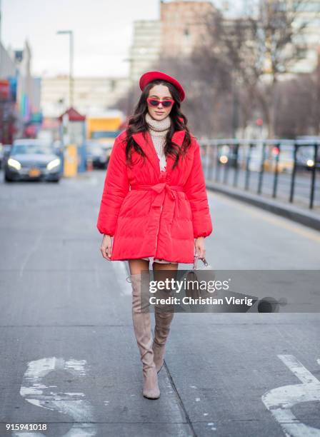 Mary Leest wearing red beret, turtleneck, red puffer jacket, overknees boots seen outside Creatures of Comfort on February 8, 2018 in New York City.