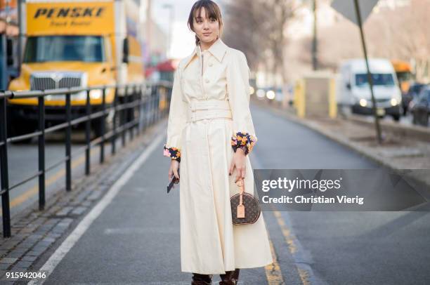 Guest wearing belted coat, round Louis Vuitton bag seen outside Creatures of Comfort on February 8, 2018 in New York City.