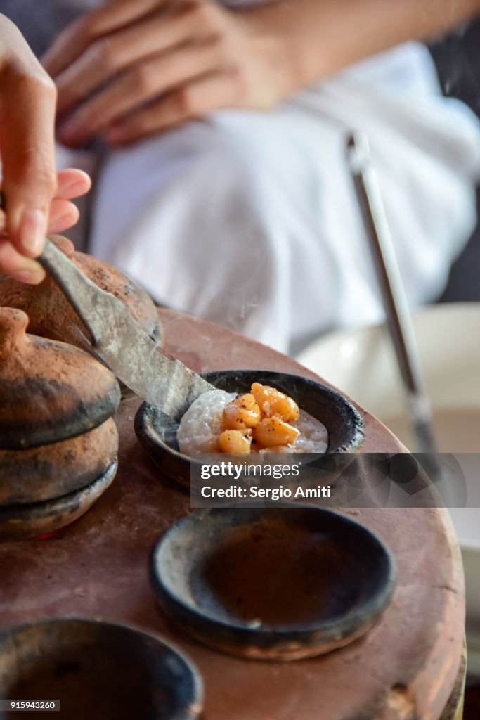 Removing a Bánh Bèo, Vietnamese savory rice tea cake from its baking mould using a spatula