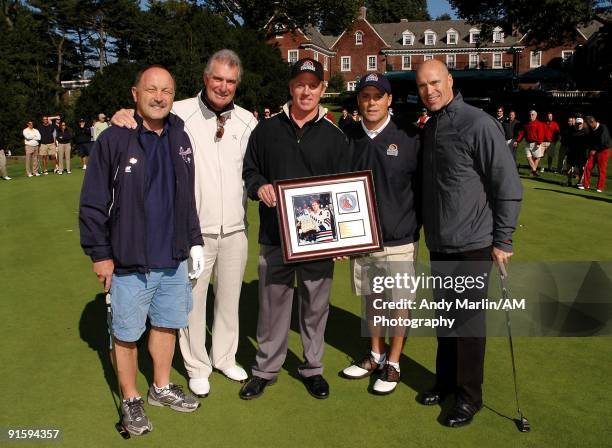 Former NHL player Brian Leetch who will inducted into the Hockey Hall of Fame this year is presented a plaque by NHL Hall of Famer members Bryan...