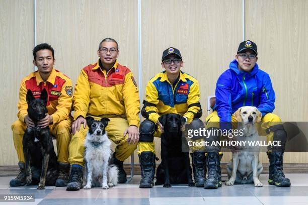 In this picture taken on February 8 earthquake search and rescue dog trainers Chou Tsung-chi , Lin You-zhun ; Li Chun-sheng and their colleague and...