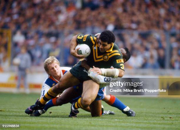 Denis Betts and Ellery Hanley of Great Britain rugby league tackle Mal Meninga of Austalia during their International match at Wembley Stadium in...