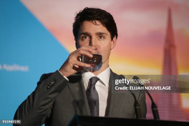 Canadian Prime Minister Justin Trudeau takes a drink of water during a visit to the offices of AppDirect as part of his three-day United States tour...