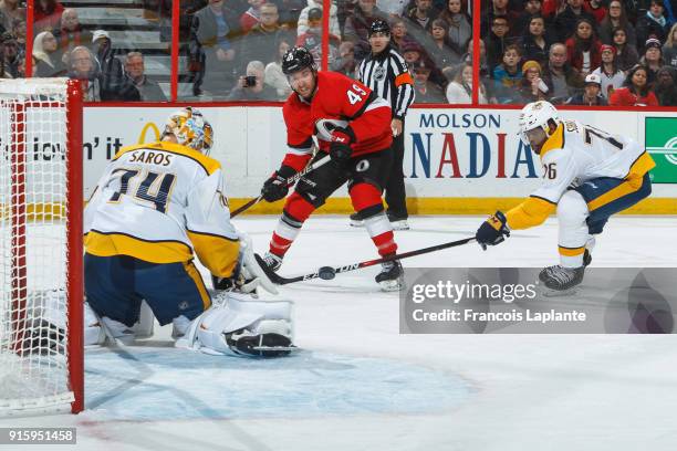 Christopher DiDomenico of the Ottawa Senators shoots wide as P.K. Subban of the Nashville Predators defends and Juuse Saros guards his net at...