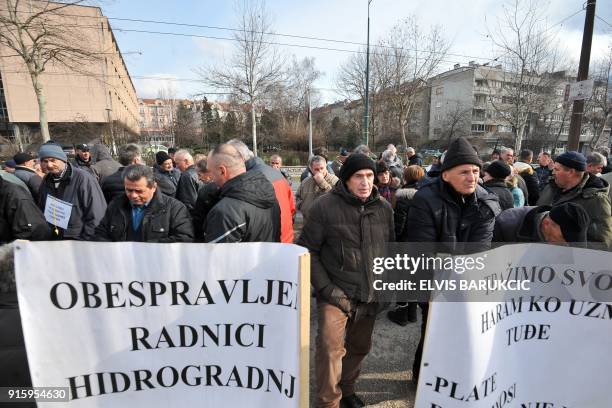 Workers of the construction company "Hidrogradnja" hold placards as they demonstrate in front of the government building in Sarajevo, on February 5,...