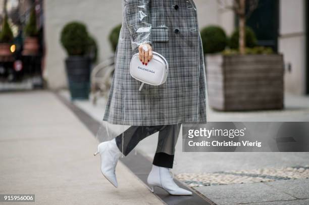 Maria Hatzistefanis wearing Calvin Klein coat, Balenciaga bag, Tabitha Simmons white boots seen on February 8, 2018 in New York City.
