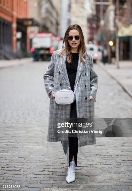 Maria Hatzistefanis wearing Calvin Klein coat, Balenciaga bag, Tabitha Simmons white boots seen on February 8, 2018 in New York City.